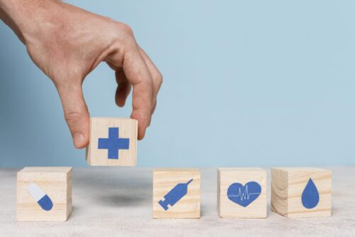 Hand place wooden blocks onto table.